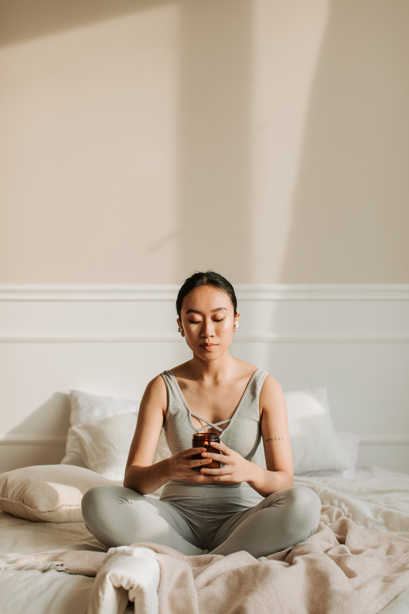 Woman Meditating While Holding a Lighted Candle